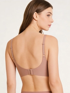Detail view of the seamless back clasp design and adjustable straps on nude pink bra