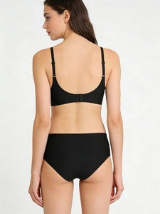 Seamless wireless black lingerie set with thin straps and low back view on a model