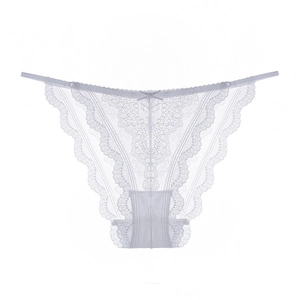 Detail of white floral lace underwear showing intricate embroidery and a small ribbon bow