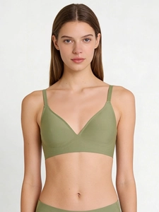 Detail of seamless bean green wireless bra set featuring smooth high-stretch fabric