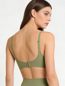 Olive green seamless U-back sports bra and high-waist panty set on model