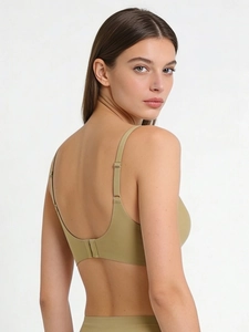 Detail view of seamless olive green bra with adjustable straps and smooth texture