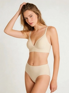 Detail view of seamless beige lingerie set showing the V-neck bra and high waist panties