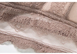 Macro shot of fine floral lace texture and scallop eyelash trim on the triangle bra