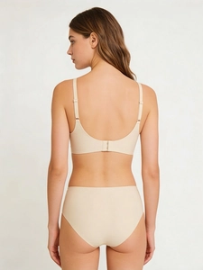 Rear view of seamless beige lingerie set showing adjustable straps and U-shaped back design