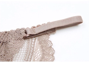 Close-up of fine lace embroidery and elastic straps on U-shaped backless bra