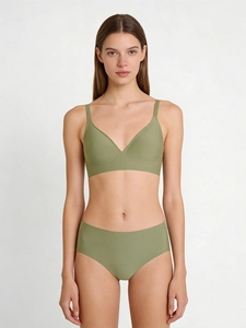 Detail of olive green seamless V-neck bra and matching panties with smooth fabric texture