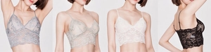 Detail view of lace bralettes in grey, apricot, white and black colors with floral patterns
