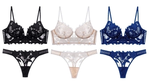 Detailed flat lay of lace lingerie sets with floral embroidery in black, beige and blue