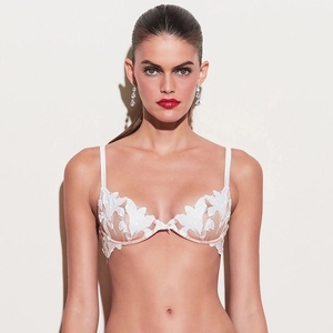 Detail of white lace embroidery bra with underwire support and floral applique