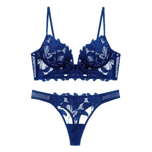 Detail of royal blue French lace lingerie set featuring delicate floral embroidery and sheer mesh