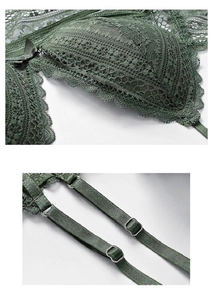 Close-up of emerald green lace bra cup with satin bow and metallic strap hardware
