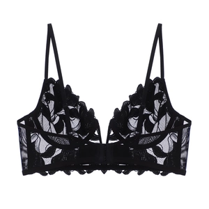 Detail of black floral lace bra with deep V-neck, delicate embroidery and sheer mesh texture