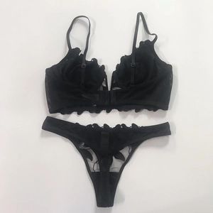 Detail of black lace lingerie set with floral embroidery and mesh bra craftsmanship