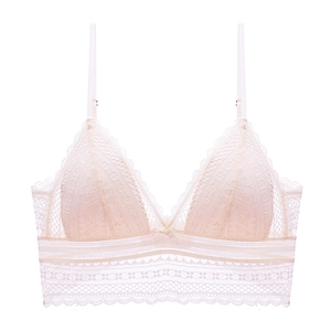 Detailed close-up of cream lace triangle bra featuring delicate floral mesh and a center bow