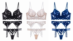 Flat lay of floral lace lingerie sets with garter belts in black, blue and champagne