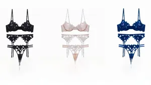 Detailed embroidery view of floral lace bra with garter and thong in three colors