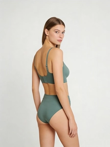 Rear view of seamless sage green lingerie set showing elastic adjustable straps and fit