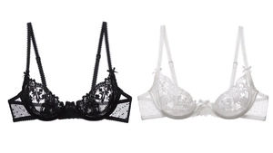 Detail view of sheer floral embroidery and dotted mesh on black and white lace bras