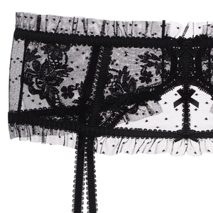 Detailed macro view of black floral lace garter belt with mesh dots and satin bow