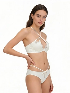 Detailed view of white satin lingerie set with lace trim and halter neck strap