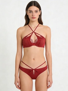 Detail of burgundy satin lingerie set with delicate eyelash lace and cross-neck strap design