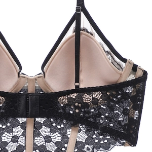 Détail d'un soutien-gorge en dentelle florale noire avec bretelles réglables et agrafage dos