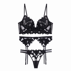 Three-piece black lingerie set with floral embroidery, garter belt and sheer mesh bra
