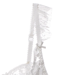 Détail d'un soutien-gorge en dentelle blanche avec broderie florale et petit nœud satin