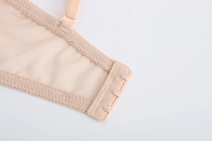 Close-up of beige lace bra back closure featuring breathable mesh fabric and adjustable hooks