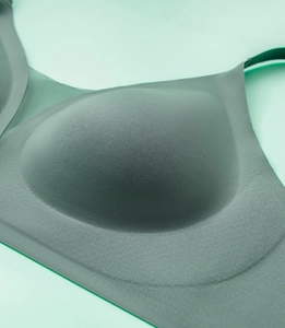 Close-up of seamless dark green V-neck bra with breathable knit texture and thin straps
