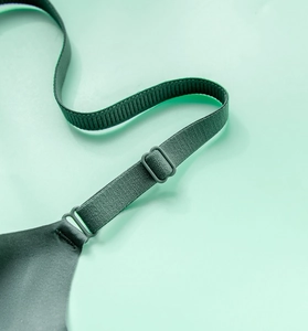 Detailed close-up of dark green seamless bra featuring ribbed strap and adjustable buckle