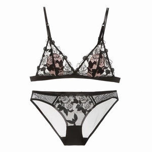 Detailed view of black lace bralette set with rose embroidery and fine mesh texture