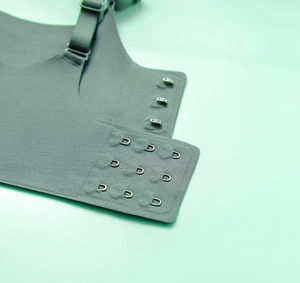 Detail view of seamless back closure featuring a 3-row hook-and-eye design in dark green