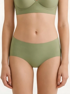 Detail view of seamless olive green lingerie set showing elastic fabric texture on model