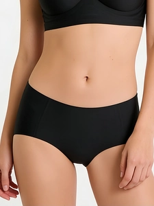 Detail of black seamless high-waist panties in soft stretchy fabric on model
