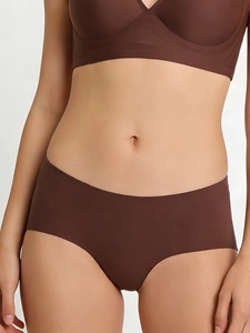 Close-up of brown seamless underwear set with laser-cut edges on a female model