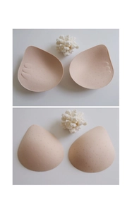 Macro shot of breathable beige bra pads with massage texture and perforated vent holes