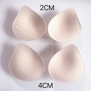 Detail view of 2cm and 4cm thickness options for beige teardrop-shaped bra pad inserts