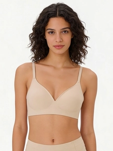Seamless nude deep-V wireless bra and high-waisted panty set on model in front view