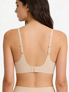 Detail view of the seamless U-back design and adjustable straps on skin-tone bra set