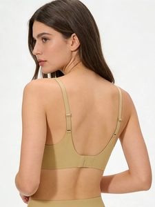 Detailed back view of a beige seamless bra featuring a deep U-shape design and slim straps