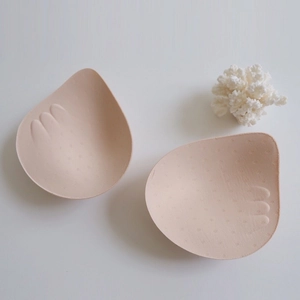 Seamless push-up bra pads with anti-slip finger texture and breathable holes in beige color