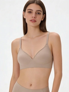 Deep V-neck seamless wireless bra with thin straps in nude beige smooth fabric