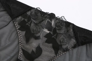 Macro detail of French triangle bralette featuring rose embroidery and black lace mesh