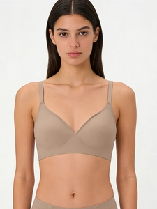 Detail view of seamless jelly bra in skin color with slim straps on model in studio