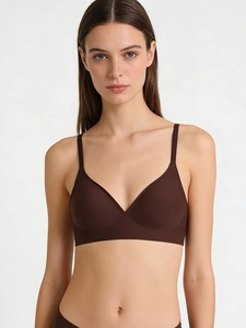 Detailed view of dark brown seamless bralette with smooth fabric and slim straps