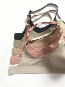 Detailed stack of multi-color seamless wireless bras showing smooth texture and side support