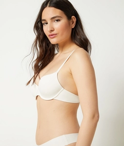 Detailed close-up of white seamless push-up bra and matching panties on a model