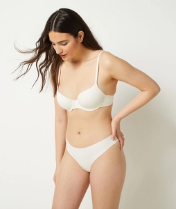 Macro detail of seamless white push-up bra set with smooth cup texture and thin straps